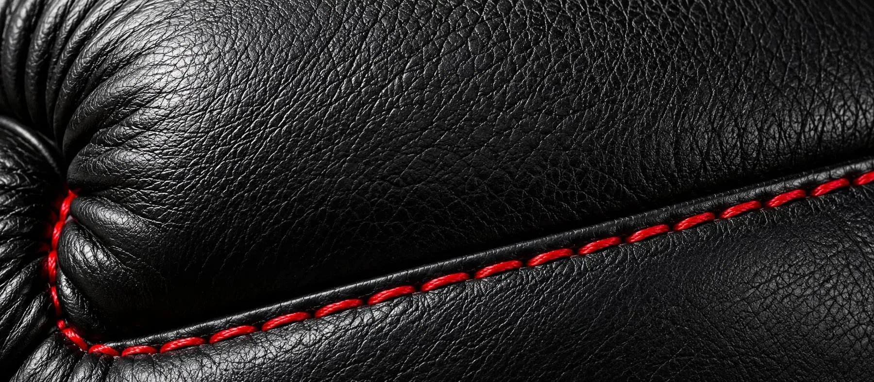 A close-up of genuine leather, its grain and natural variation visible.