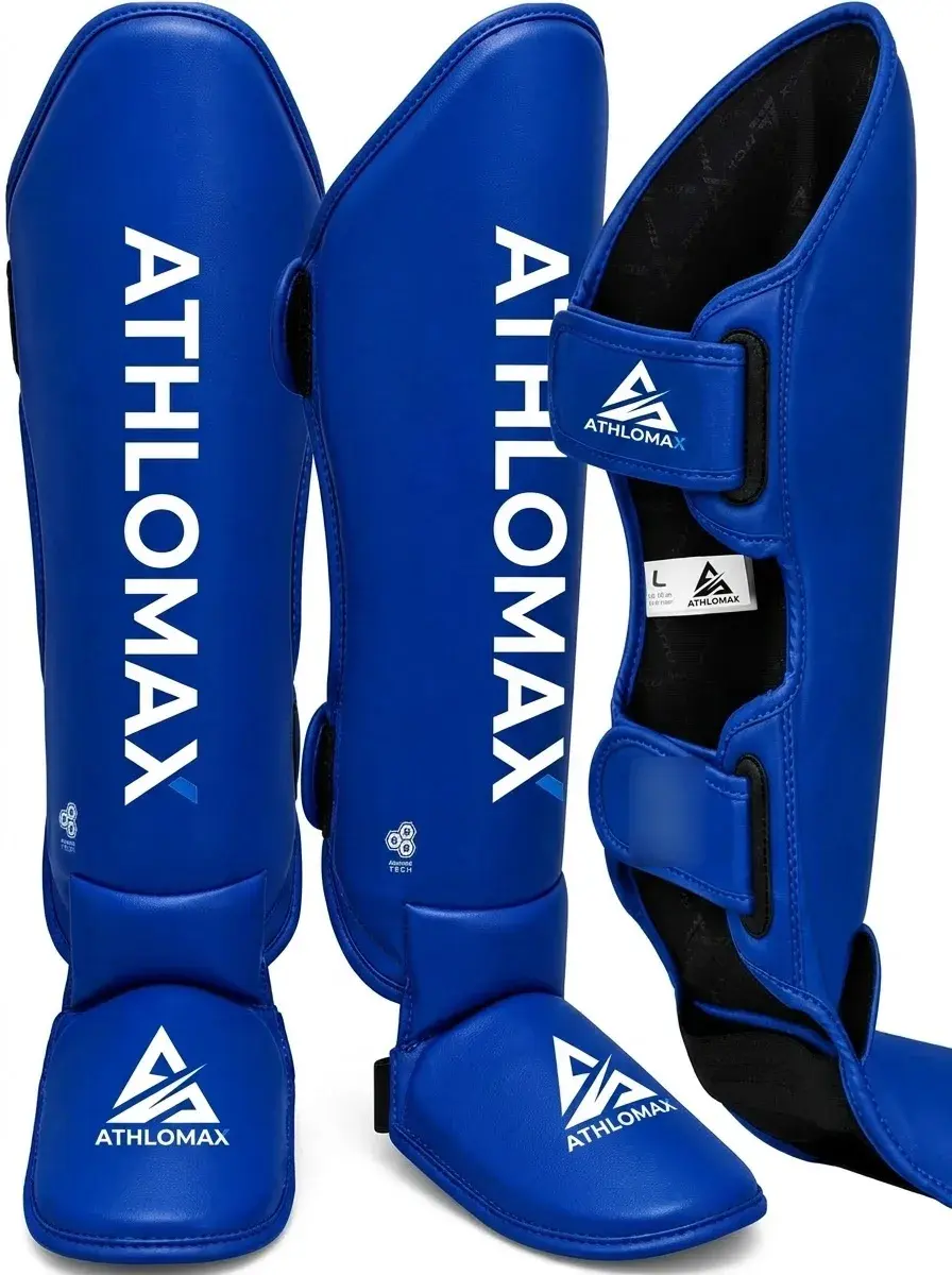 A pair of royal blue Athlomax shin and instep guards with the white Athlomax wordmark running down each shin and the logo on the instep.