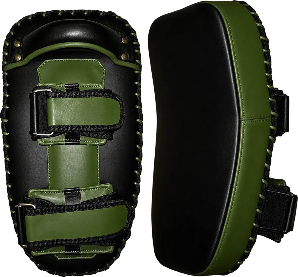 A pair of black and olive Thai pads, one showing the back with two buckled olive forearm straps and a handle, the other the curved black striking face.