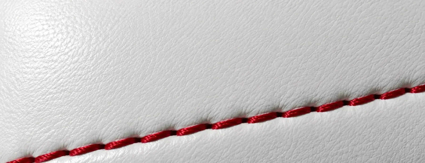 A close-up of synthetic PU leather, its even surface and consistent colour.